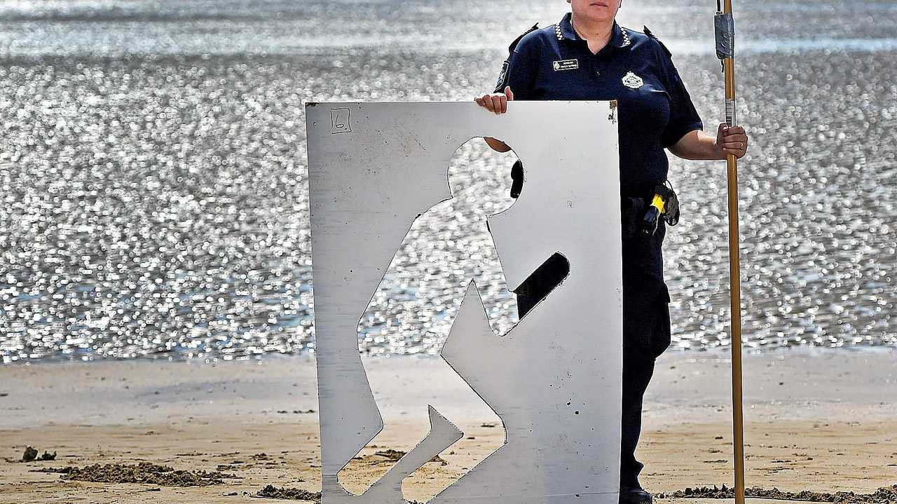 TAKING A STAND: Maryborough patrol group domestic and family violence coordinator Sergeant Hayley Skyring making sand silhouettes at the Fraser Coast Domestic and Family Violence Alliance&#39;s awareness event. Picture: Cody Fox