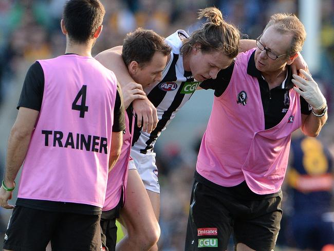 Tom Langdon is helped from the field after injuring his ankle. Picture: Daniel Wilkins