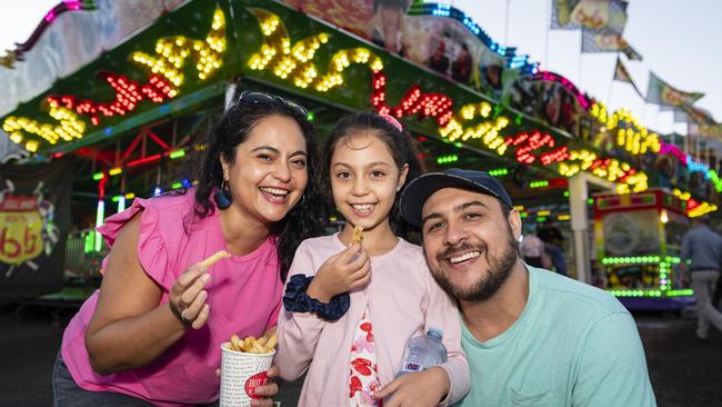 Paola Bravo and Alejandro Ulloa with their daughter Julieta Ulloa enjoy sideshow alley at the Toowoomba Royal Show, Thursday, March 30, 2023. Picture: Kevin Farmer