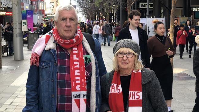 Sydney Swans fans Barry and Carolyn Marks sympathised with Crows supporters. Picture: Shashi Baltutis