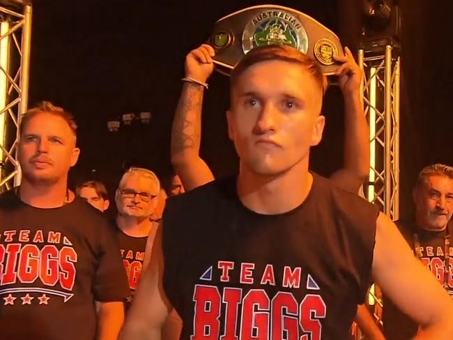 Dylan Biggs walks to the ring