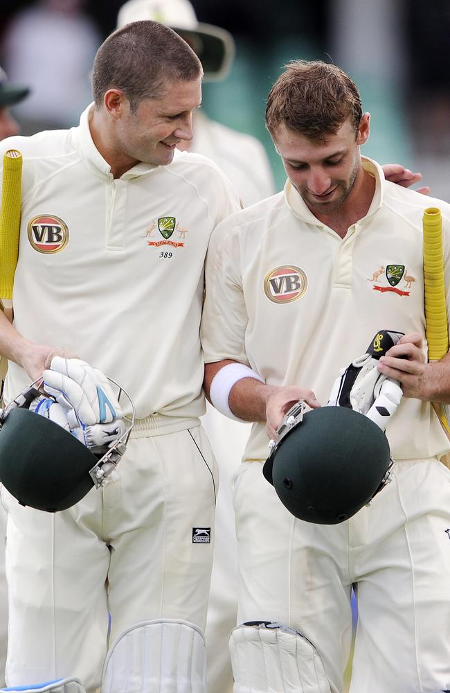 Michael Clarke gives Phillip Hughes a pat on the back at the end of a day’s play in Durban in 2009.