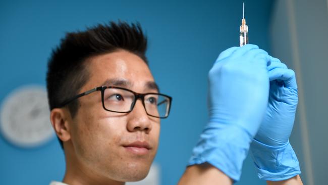 Pharmacist Robert Luon prepares a flu vaccination. Picture: Penny Stephens