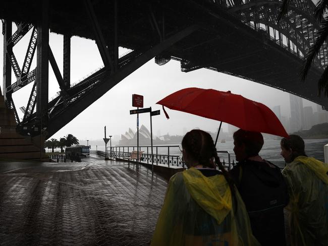 Wet scenes in Sydney at Luna Park today as rain fall smashes the East coast of Australia. Picture: Sam Ruttyn