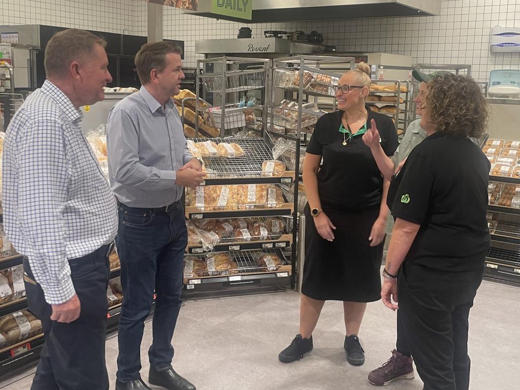 Jarrod Bleijie and David Lee speak with Woolworths workers Cass Hicks and Lisa Bowers at Eli Waters on Thursday.