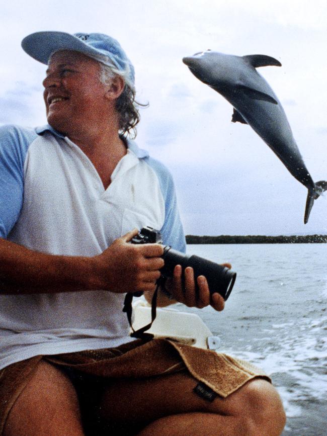 Marine biologist Dr Mike Bossley and a leaping dolphin in 1991.