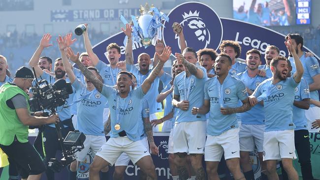 Manchester City's Belgian defender Vincent Kompany (C) holds up the Premier League trophy as City's players celebrate after their 4-1 victory in the English Premier League football match between Brighton and Hove Albion and Manchester City at the American Express Community Stadium. Picture: Glyn Kirk/AFP