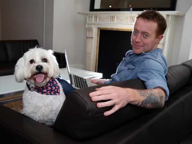 Paul Armstrong with Nala the dog at Sitback Solutions, Sydney. Picture: Craig Wilson