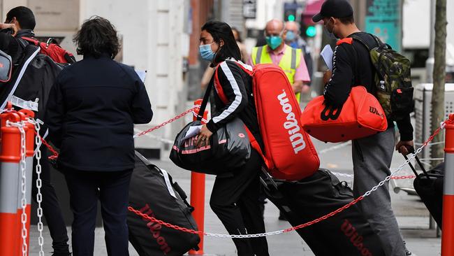 Tennis players, coaches and officials arrive at a hotel in Melbourne on Friday. Picture: William West/AFP