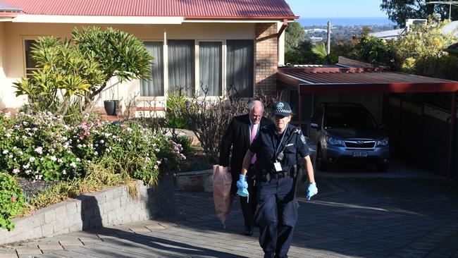 Detectives and Major Crime remove what appears to be a gas canister from the Eden Hills home. Picture: Tricia Watkinson