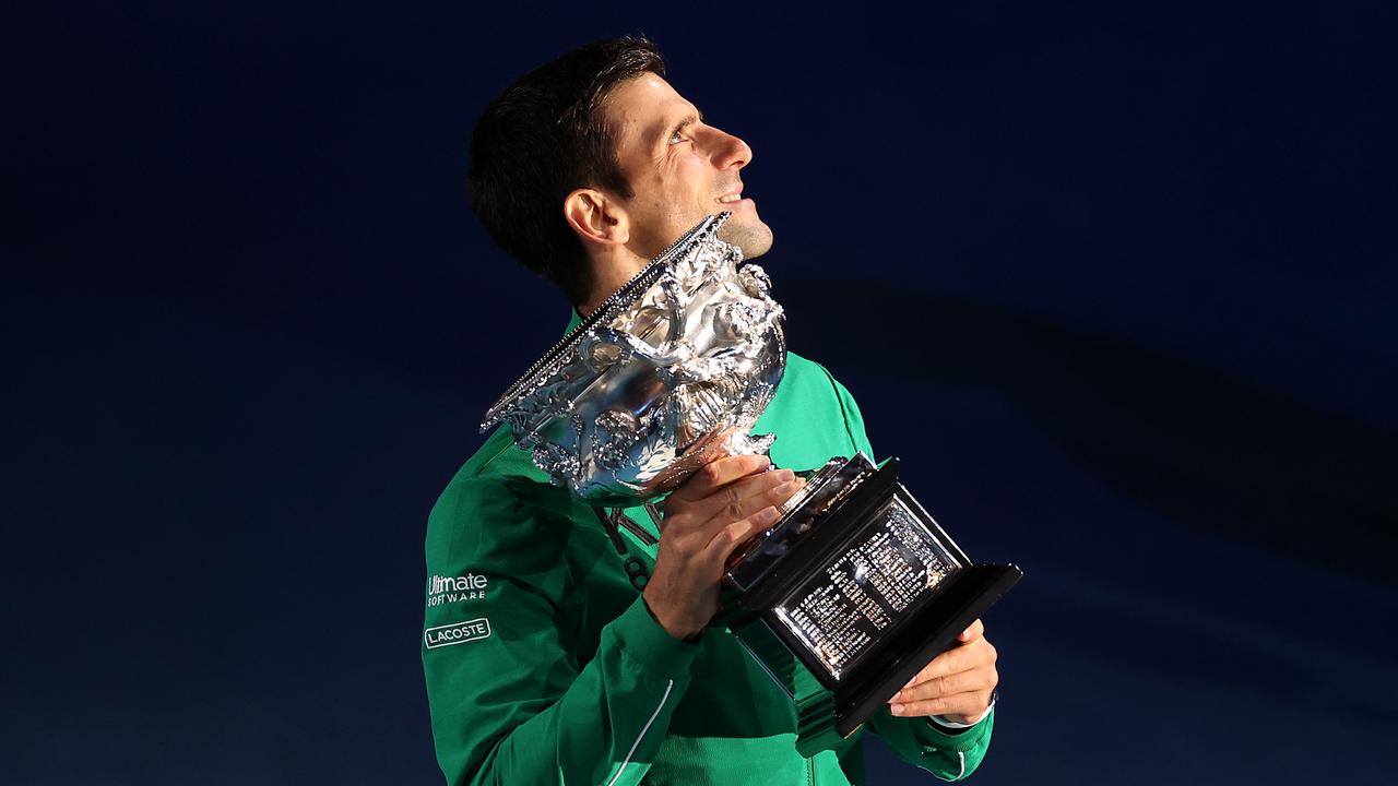 Novak Djokovic poses with the Norman Brookes Challenge Cup after winning his eighth Australian Open.