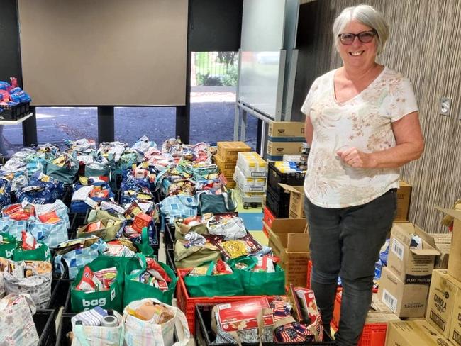 Coordinator of The Bird Cage community store Christine Mackaness with food relief hampers. Picture: The Bird Cage community store.