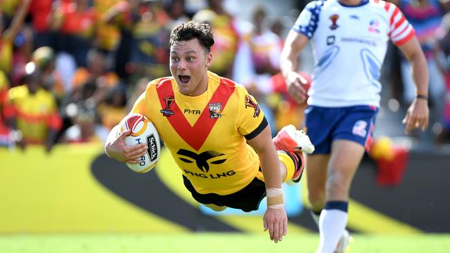 Lachlan Lam flies in for a try for Papua New Guinea during the Rugby League World Cup.