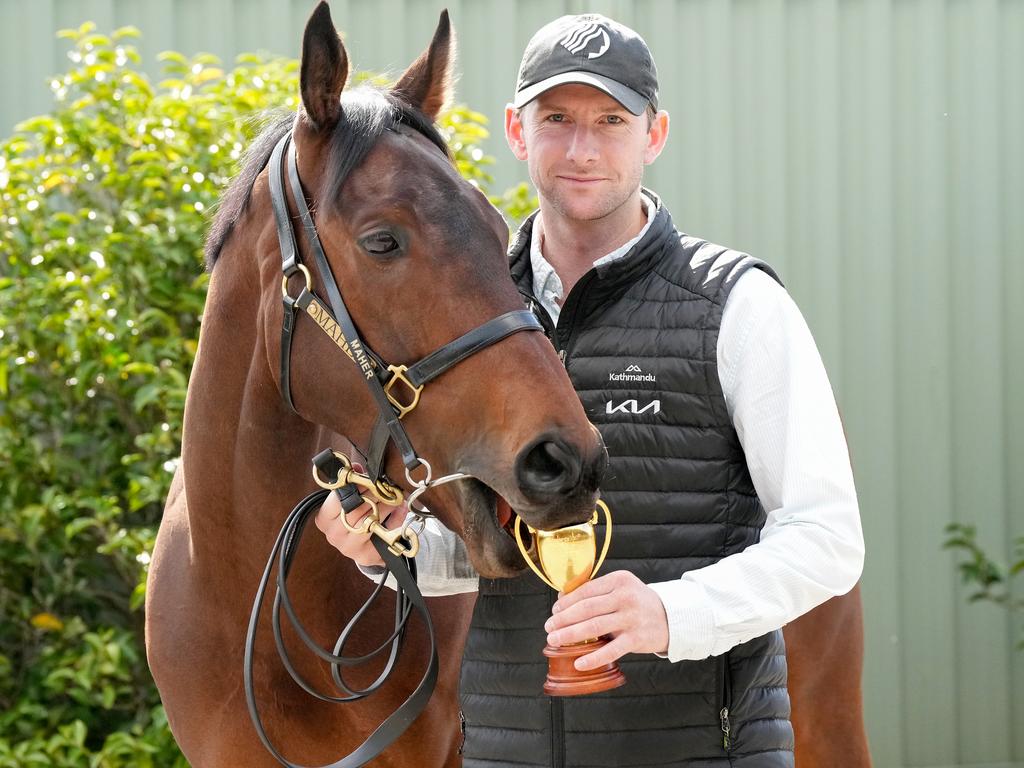 Caulfield Cup Winner Duke De Sessa has a taste of the trainer’s trophy with Ciaron Maher’s assistant, Jack Turnbull, at Cranbourne on Sunday. Picture: George Sal / Racing Photos