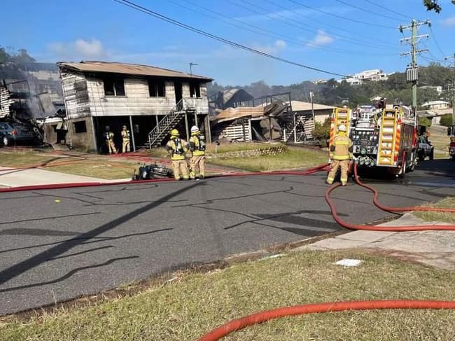 Firefighters at the scene of a fire this morning where two houses in Agnes Street, Gladstone, were destroyed.