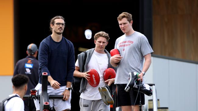 Phil Davis, Lachie Whitfield and Tom Green take gym equipment and footballs from the club. Picture. Phil Hillyard