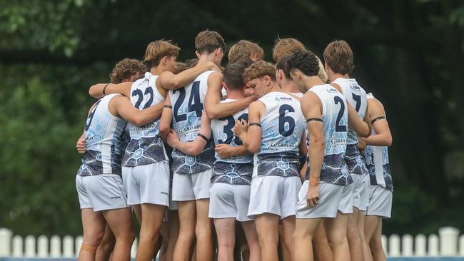 Chris Evans, second from left, and Oscar Bannister, far right, listen to coach Sam Wiltshire’s address. They have both started strongly for the Roos. Photos by Stephen Archer