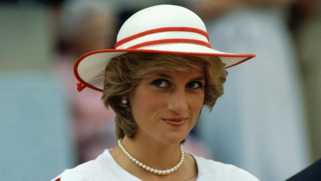 Diana, Princess of Wales, wears an outfit in the colors of Canada during a state visit to Edmonton, Alberta, with her husband.