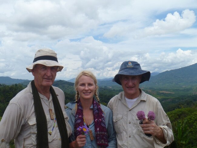 Family mission in rugged terrain ... Georgi Glover on the Sandakan Death March route with (left) father Richard Glover and uncle Geoff Glover, holding flowers for the fallen.