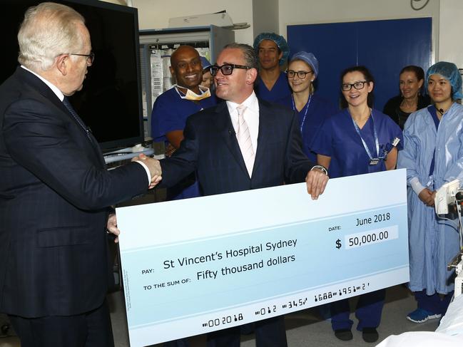 Cardiologist Professor Michael Fenelly accepts the $50k donation cheque from Carlo Massetti. Picture: John Appleyard