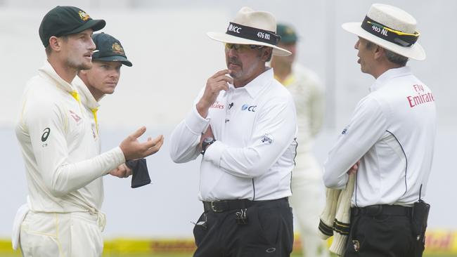 Umpires Nigel Llong and Richard Illingworth question Australian fieldsman Cameron Bancroft during day three of the third Test against South Africa in Cape Town last year. Picture: Getty Images 