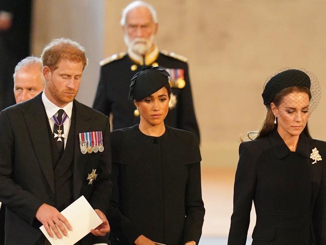 Prince Harry, Duke of Sussex, Meghan, Duchess of Sussex and Catherine, Princess of Wales stand at the coffin of Queen Elizabeth II lays on the catafalque at Westminster Hall on September 14, 2022, in London. Picture: Jacob King – Pool/Getty Images