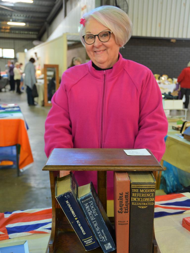 Enjoying the 2023 Toowoomba Antique Collectable Fair and Car Show is Marg Christensen with a revolving bookcase which once sat on a solicitor's desk in the early 1900s. Picture: Rhylea Millar