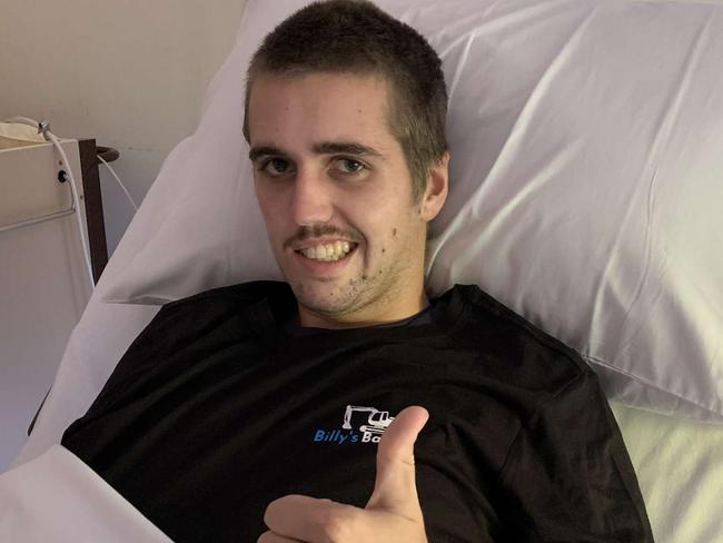 Billy Bubb in his hospital bed after mastering how to do the thumbs up.