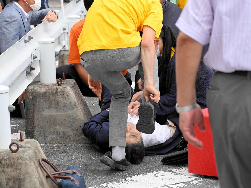 Abe collapsed on the ground after being shot at Yamato Saidaiji Station in the city of Nara on July 8, 2022. Picture: Asahi Shimbun / AFP