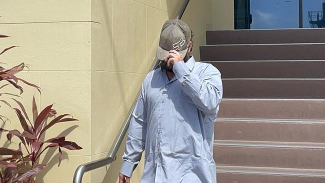 The 36 year old tried to hide his face after leaving Mackay courthouse. Picture: Janessa Ekert