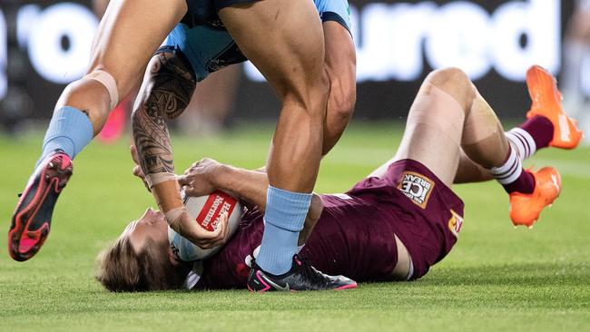 Cameron Munster hits the ground after competing for the ball with Tyson Frizell.