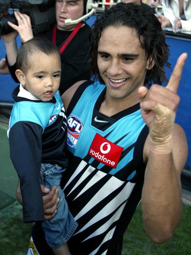 Peter Burgoyne celebrates with Trent after winning the 2004 AFL grand final.            Picture: News Corp.