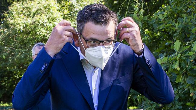 MELBOURNE, AUSTRALIA - NewsWire Photos February 17, 2022: (L-R) Victorian Premier Daniel Andrews puts on a mask after a press conference at Parliament. Picture: NCA NewsWire / Aaron Francis