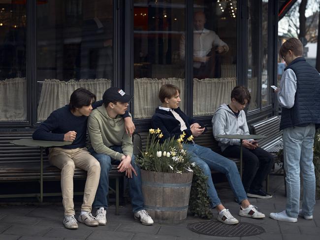 Youths hang out outside a restaurant in Stockholm, Sweden. Picture: AP