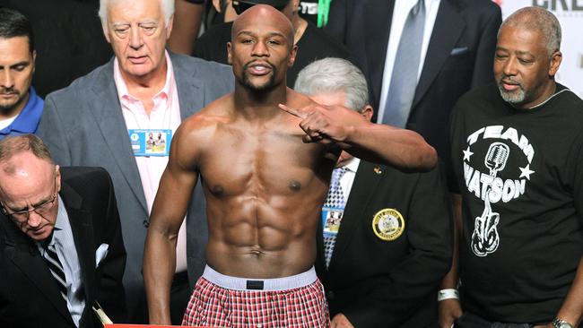 Floyd Mayweather Jr. gestures during his weigh-in with Andre Berto on September 11, 2015 at the MGM Grand in Las Vegas. Mayweather will defend his WBC/WBA welterweight titles against Andre Berto on September, 12 at the MGM Grand in Las Vegas. AFP PHOTO/ John Gurzinski