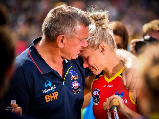 Greg Phillips embraces his daughter Erin after the AFLW Grand Final match between the Adelaide Crows and the Carlton Blues at Adelaide Oval last March. Picture: Getty Images