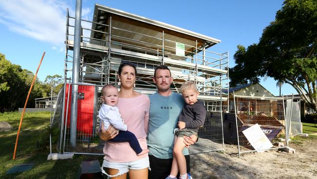 Ryan and Kristy Waterworth and their children Nash and Piper outside their unfinished Coombabah home. Picture: David Clark