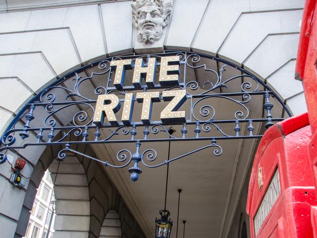 ESCAPE London, United Kingdom - May 16, 2013: The Ritz Hotel logo, illuminated with light bulbs and mounted on wrought iron work under the front arches of the Ritz building, Piccadilly, London, UK. The Ritz, opened in 1906, is a luxury hotel and international landmark in the west end of London. Picture: Istock