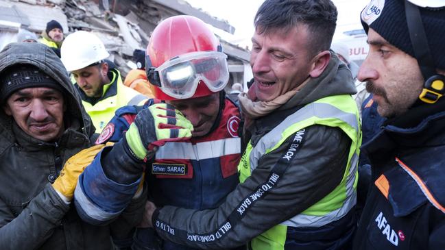 Fireman Erhan Sarac and other rescue team members celebrate each other just after a successful evacuation. Picture: Getty Images