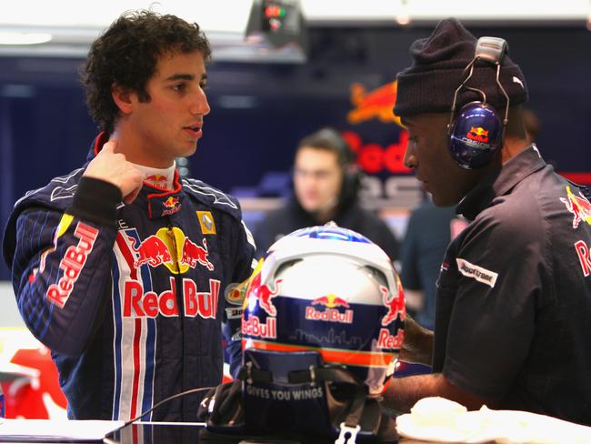 Daniel Ricciardo talks with physio Roger Cleary as he prepares to drive at the Circuito De Jerez. Picture: Mark Thompson/Getty Images