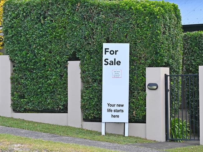 Real estate for sale sign in front of a house