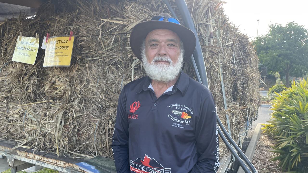 Les Mitchell at the Airlie Markets with his well-known truck and mulch, selling for $7 per bale.