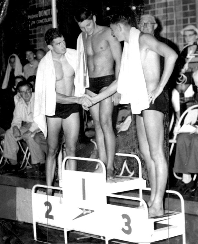 Swimmer Jon Konrads (centre) after a record-breaking 220-yards swim at the NSW championships on January 25, 1958.