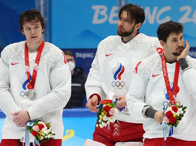 BEIJING, CHINA - FEBRUARY 20: (L-R) Dmitri Voronkov #10, Ivan Fedotov #28 and Artur Kayumov #24 of Team ROC look on during the medal ceremony after the Men's Ice Hockey Gold Medal match between Team Finland and Team ROC on Day 16 of the Beijing 2022 Winter Olympic Games at National Indoor Stadium on February 20, 2022 in Beijing, China. Team Finland defeated Team ROC 2-1. (Photo by Bruce Bennett/Getty Images)