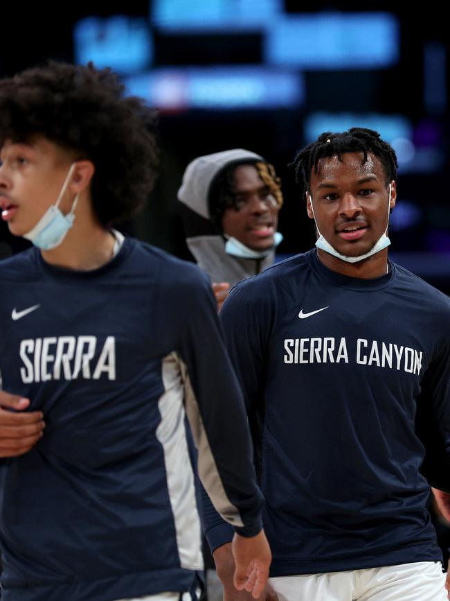 Bronny James warms up with other teammates wearing masks. Photo by Harry How/Getty Images.