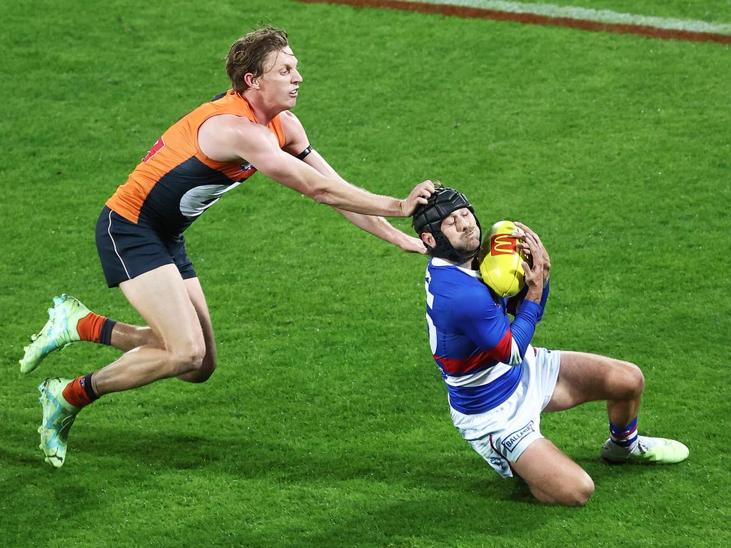 CANBERRA, AUSTRALIA - MAY 06:  Caleb Daniel of the Bulldogs is challenged by Lachie Whitfield of the Giants during the round eight AFL match between Greater Western Sydney Giants and Western Bulldogs at Manuka Oval, on May 06, 2023, in Canberra, Australia. (Photo by Matt King/AFL Photos/via Getty Images )