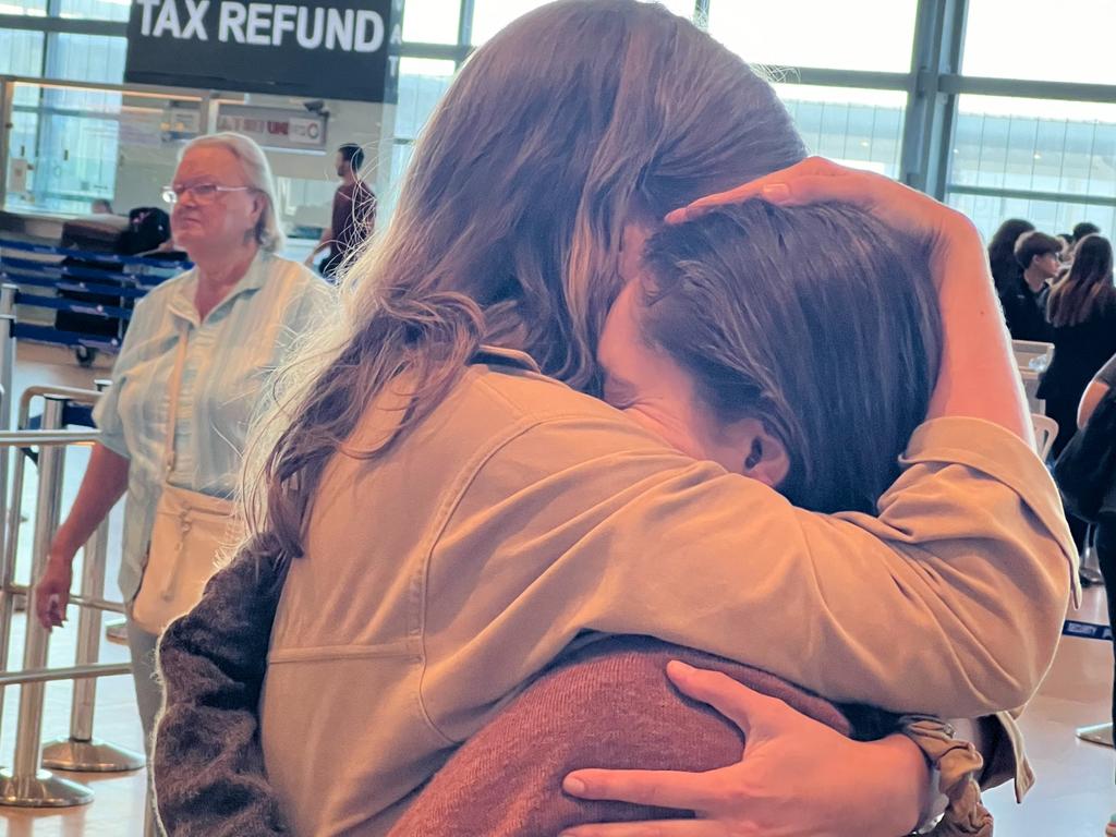 Australians Emma (surname withheld) and Hannah Blencowe embrace as they arrive at Ben Gurion Airport to fly home. Picture: Jordan Polevoy