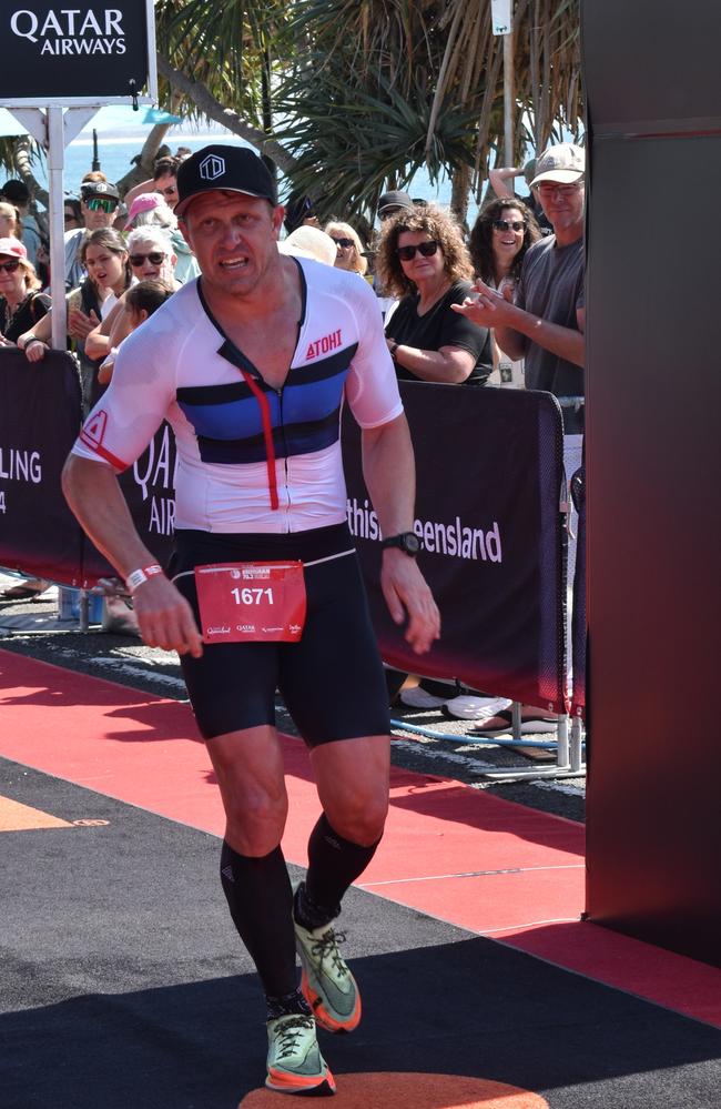 Athletes crossing the finish line at the Sunshine Coast Ironman 70.3 2023.