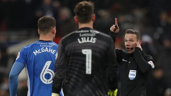 Referee Paul Tierney listens to a VAR decision on Tottenham Hotspur's Argentinian midfielder Erik Lamela's goal which is disallowed during the English FA Cup 5th round replay football match between Tottenham Hotspur and Rochdale at Wembley Stadium in February. Picture: AFP 