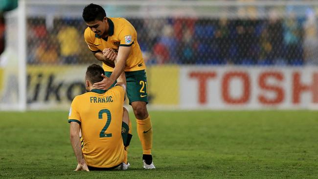 Massimo Luongo helps an injured Franjic off the pitch.